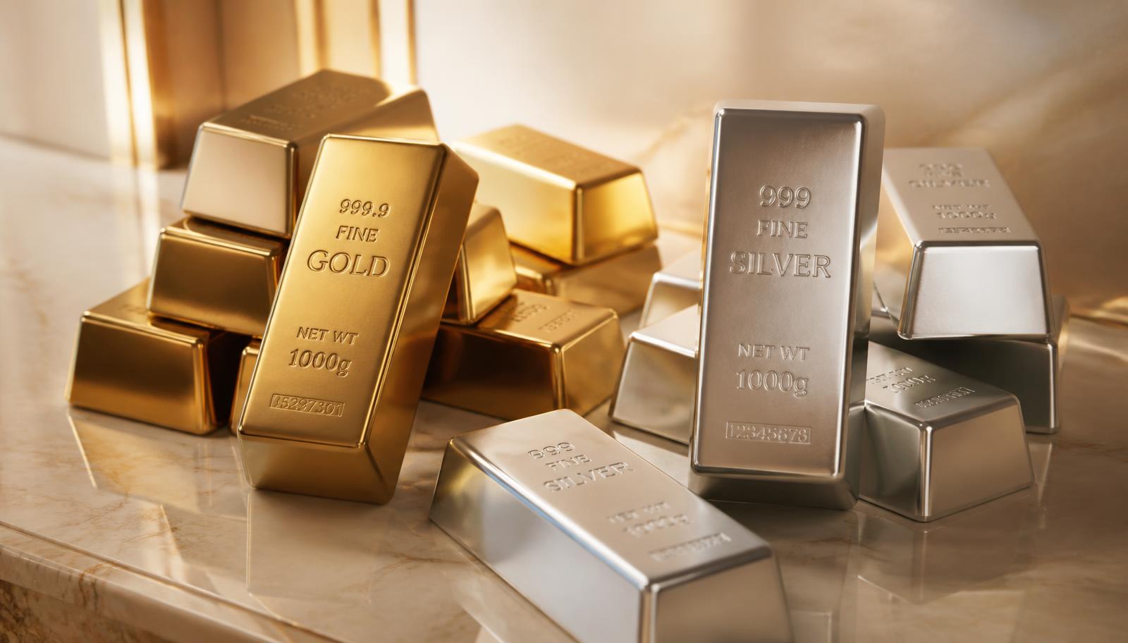Stacked 24K gold bullion bars beside 999 fine silver bars on an ivory stone surface